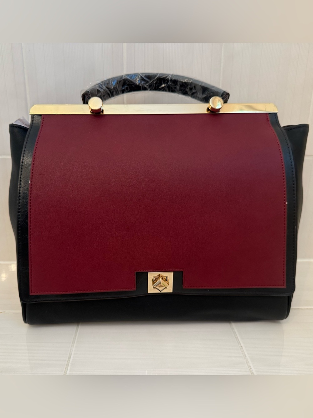 Structured Two-Tone Handbag in Burgundy and Black with Gold Hardware